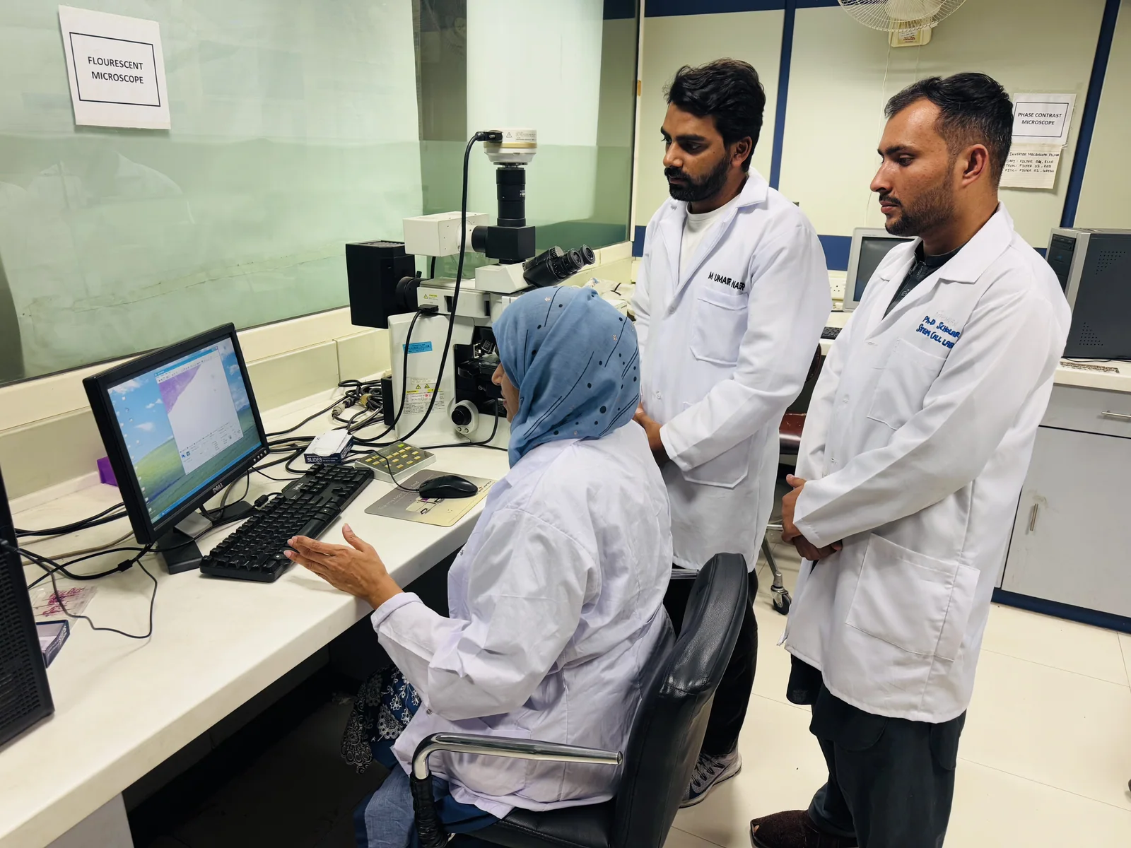 CEMB doctoral researchers analysing results at the microscopy workstation