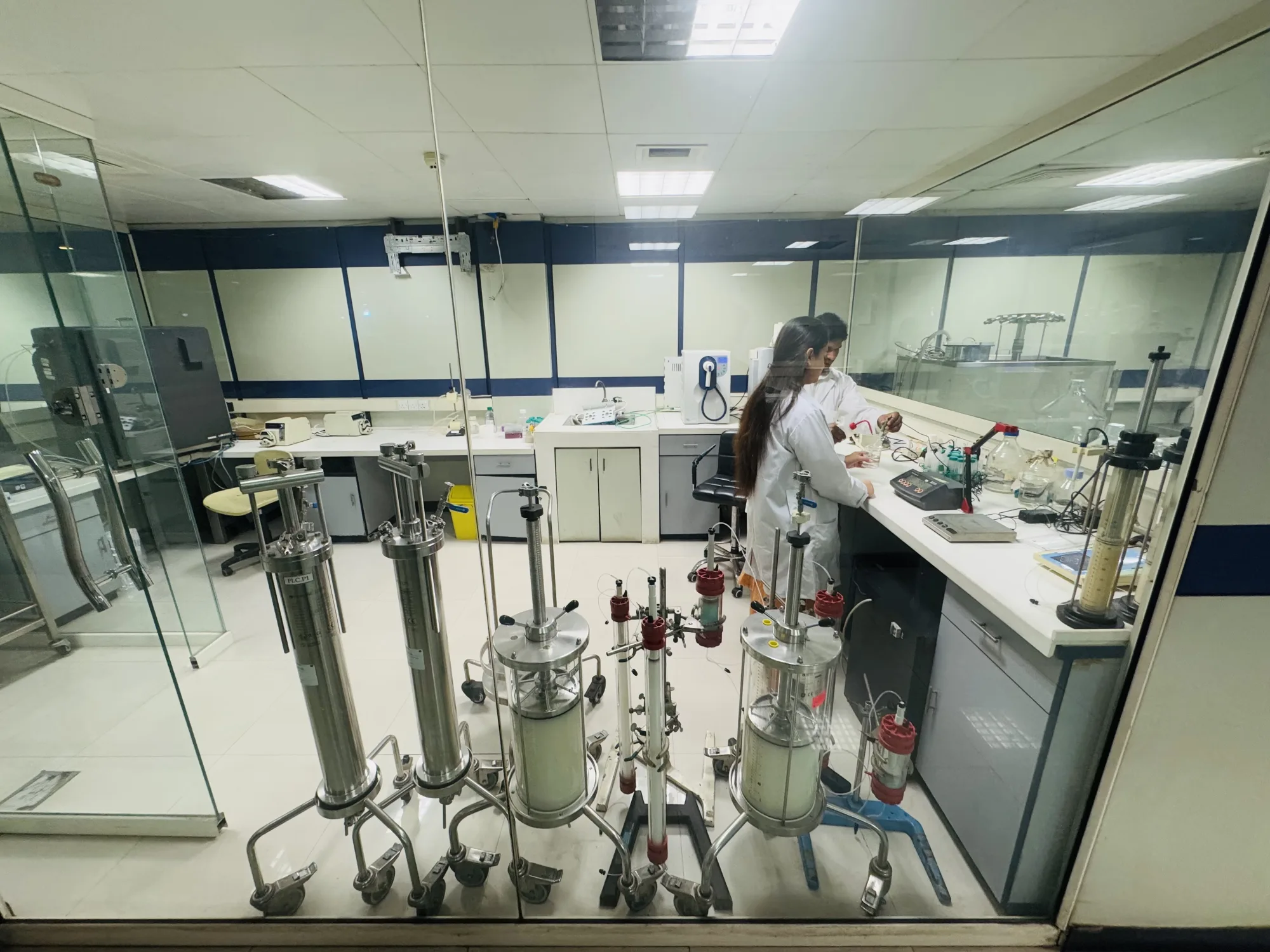 CEMB researcher working beside laboratory bioreactors