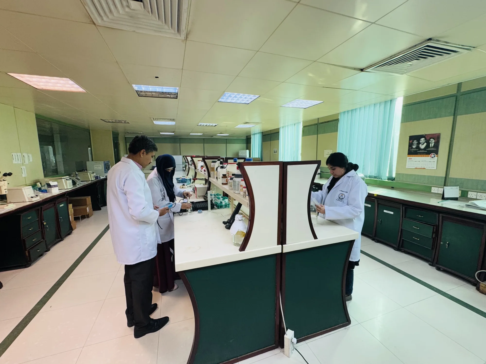 CEMB scientists collaborating around a central laboratory bench
