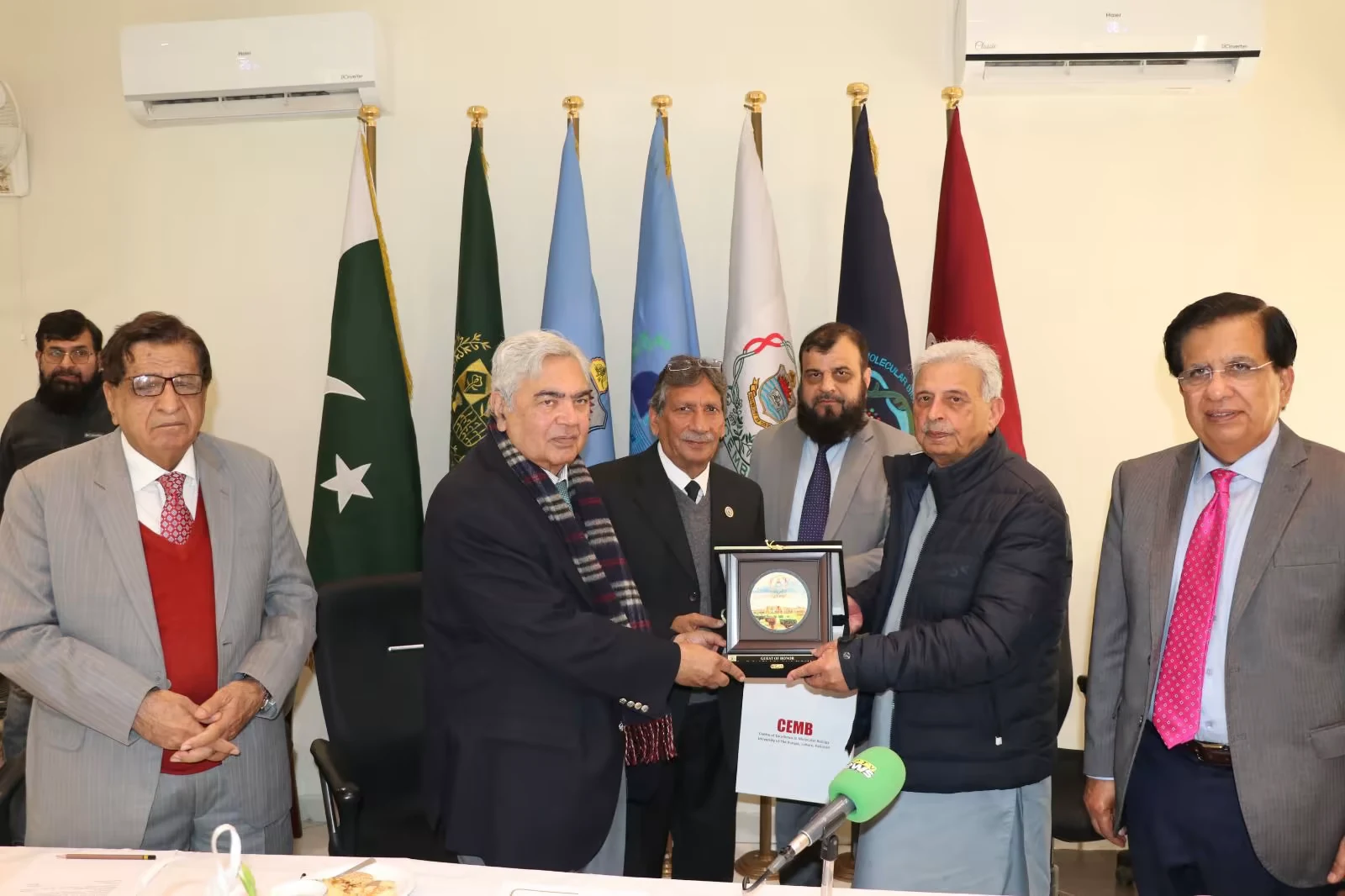 CEMB leadership presenting a commemorative shield at an award ceremony
